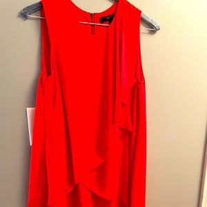 Asymmetrical cascading layered dress with a round neck. Relaxed fit.